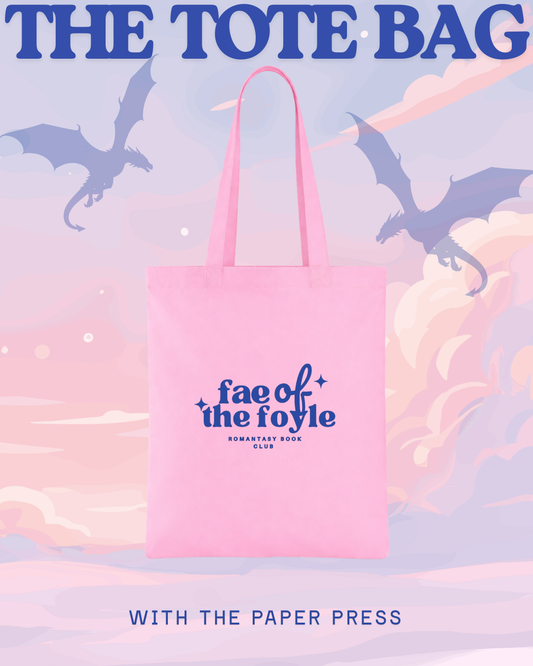 Pink tote bag with 'fae of the foyle' logo against a pastel sky with dragons