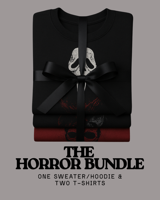 Flat lay of horror mystery bundle – one black horror sweater and two graphic horror t-shirts, hand-printed spooky streetwear.