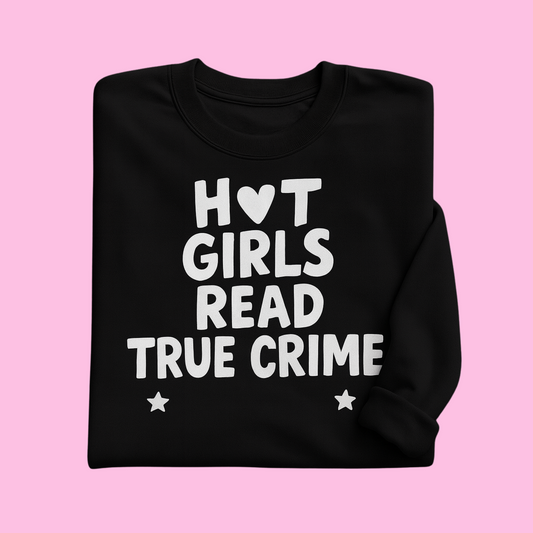 Folded black sweatshirt with bold white text “Hot Girls Read True Crime” and heart/star details, bookish fashion gift.