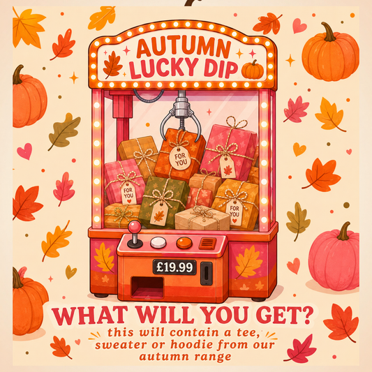 Autumn-themed promotional graphic for a 'Lucky Dip' offer, featuring a cartoon claw machine filled with wrapped gift boxes. The illustration is decorated with pumpkins, autumn leaves, and stars on a warm cream background, with text at the bottom reading 'WHAT WILL YOU GET? this will contain a tee, sweater or hoodie from our autumn range'.