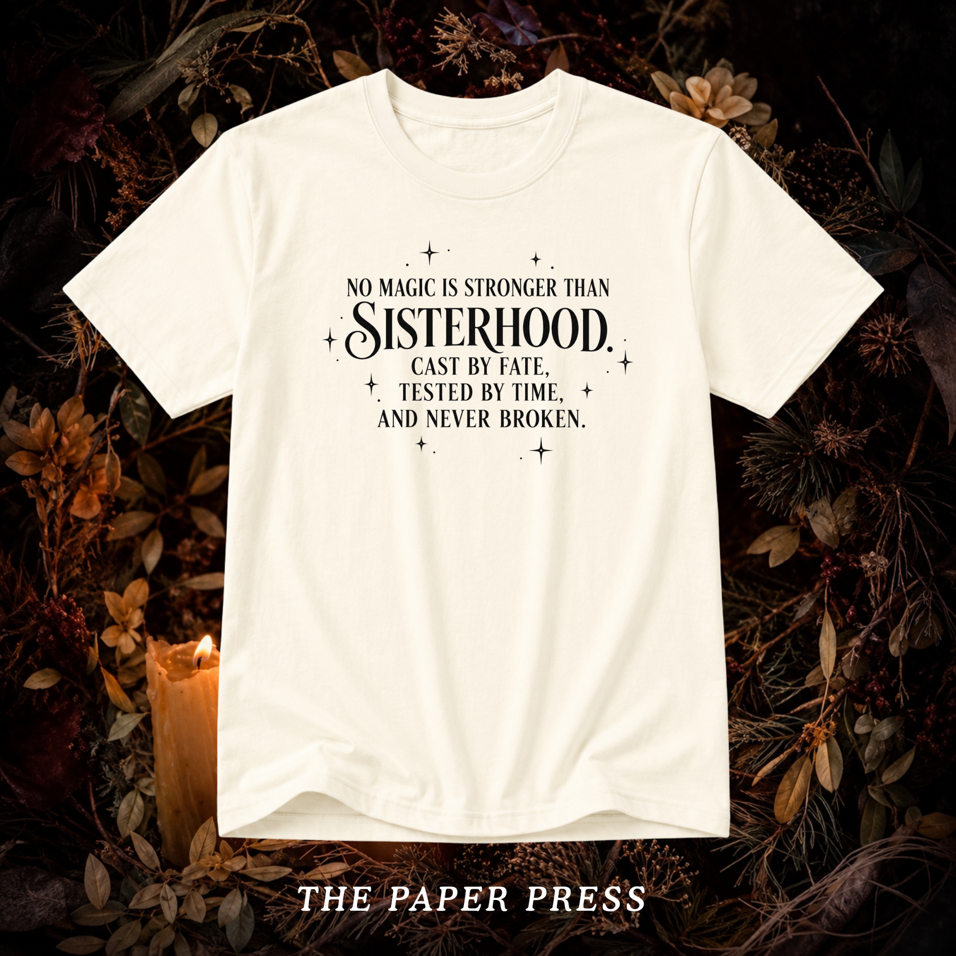 An off-white short-sleeve graphic t-shirt with black text reading 'NO MAGIC IS STRONGER THAN Sisterhood. Cast by fate, tested by time, and never broken.