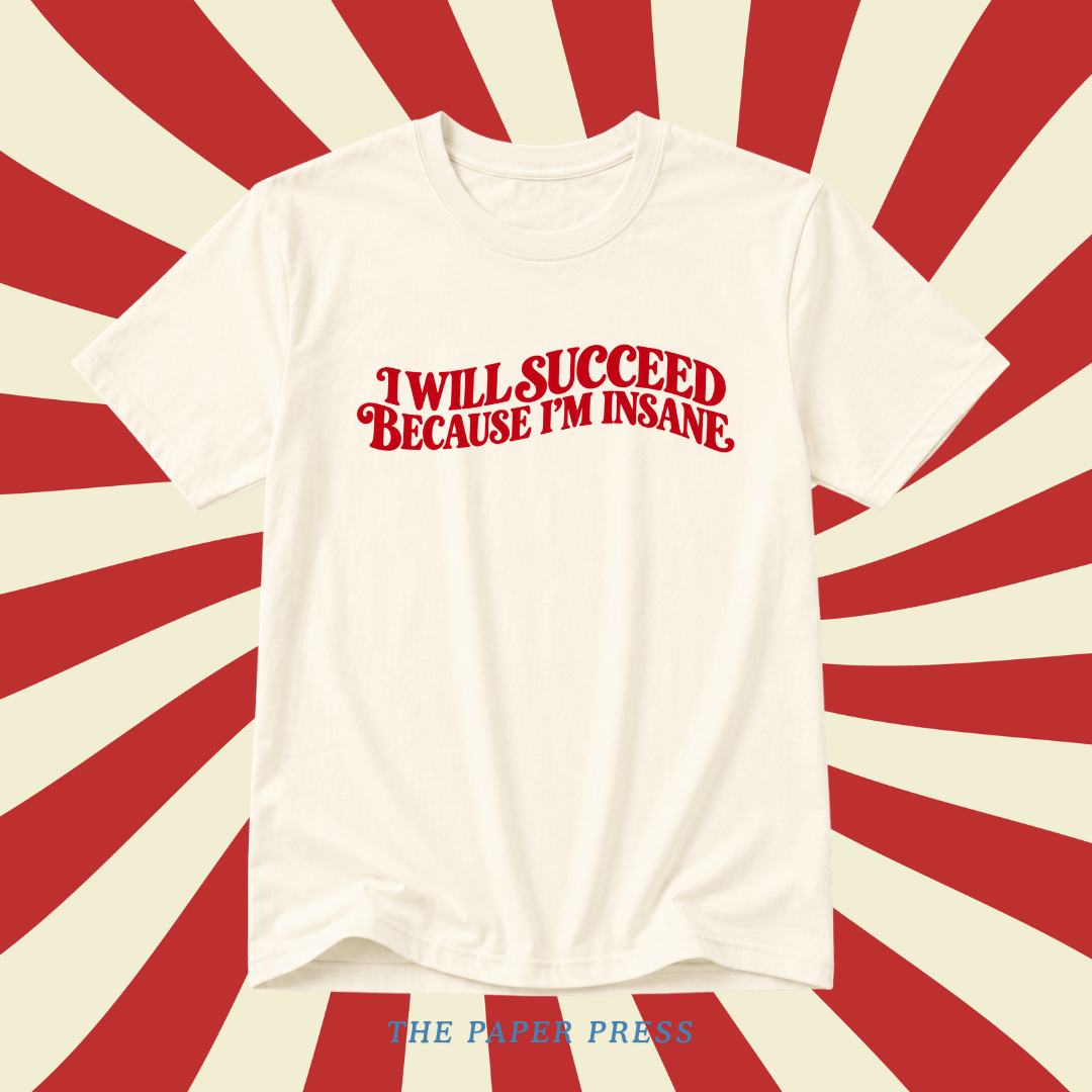 An off-white short-sleeve t-shirt with the phrase 'I WILL SUCCEED BECAUSE I'M INSANE' printed in red retro-style lettering across the chest. The shirt is displayed against a red and cream sunburst background, with 'THE PAPER PRESS' printed in blue at the bottom.
