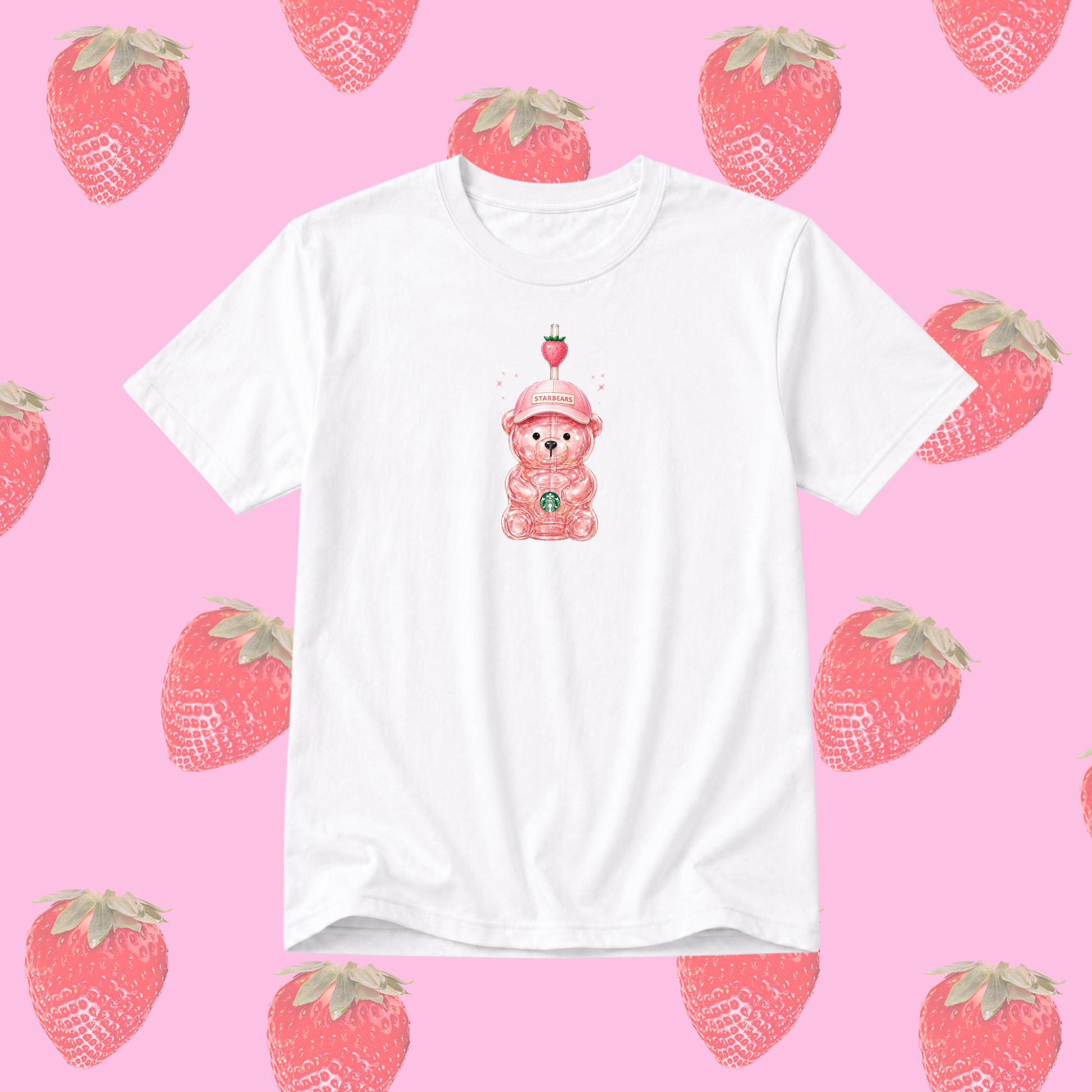 A white short-sleeve crewneck t-shirt featuring a cute pink bear graphic wearing a strawberry hat, centered on a pink background patterned with watercolor-style strawberries.