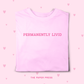 Pink t-shirt with 'PERMANENTLY LIVID' text on a pink background with heart shapes.
