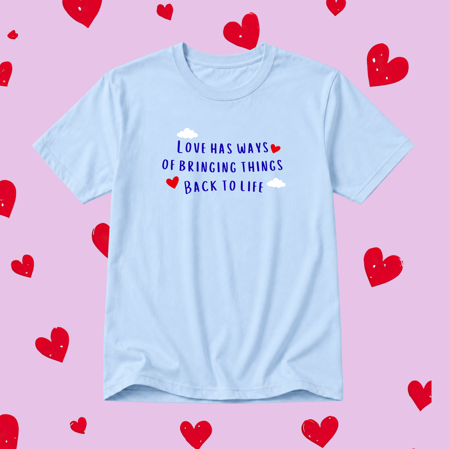 Light blue t-shirt with motivational quote on a pink background with red hearts