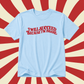 A light blue short-sleeve t-shirt with the phrase 'I WILL SUCCEED BECAUSE I'M INSANE' printed in red retro-style lettering across the chest, displayed against a red and cream sunburst background.
