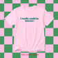 A light pink short-sleeve t-shirt with the text 'I really could be meaner.' printed in dark teal across the chest, displayed against a pink and green checkered background.