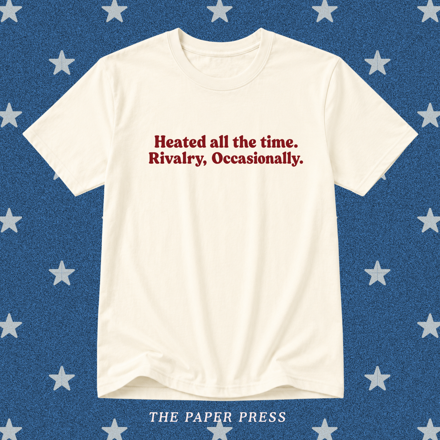 Vanilla Heated Rivalry coded T-shirt featuring the slogan “Heated all the time. Rivalry, Occasionally.” in dark red retro lettering, hand-printed by The Paper Press.