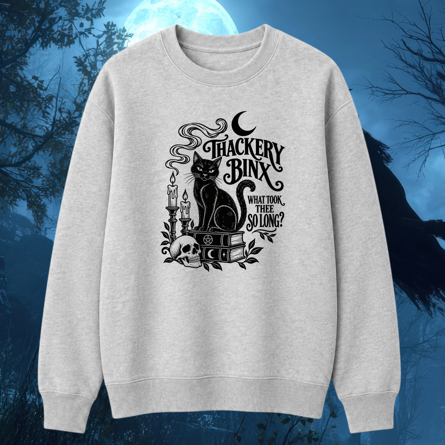A light heather gray crewneck sweatshirt featuring a black gothic-style graphic of a cat, candles, a skull, an open book, and the text 'TRACKERY BINX WHAT TOON, THERE SO LONG?' displayed against a dark blue, spooky forest background with a full moon.
