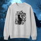 A light heather gray crewneck sweatshirt featuring a black gothic-style graphic of a cat, candles, a skull, an open book, and the text 'TRACKERY BINX WHAT TOON, THERE SO LONG?' displayed against a dark blue, spooky forest background with a full moon.