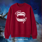 Lost Boys coded red sweater featuring a white vampire fang graphic and “Never Grow Old, Never Die” slogan, hand printed by The Paper Press.