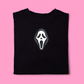 Black t-shirt with a white ghost face logo on a pink background